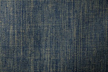 Mavi ve bej renkli, ayrıntılı ve ızgara dokusuna benzeyen bir kumaşın makro resmi. Döşeme, moda ya da tekstil tasarımı için harika..