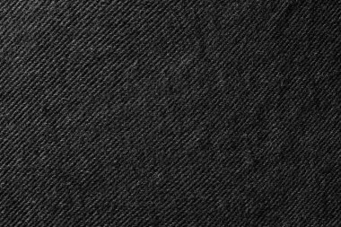 Close-up image of black denim fabric showing detailed diagonal twill weave texture.