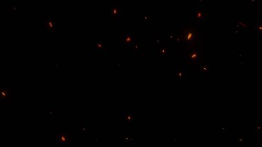 Siyah zemin üzerinde uçan ateş parçacıkları izole edildi