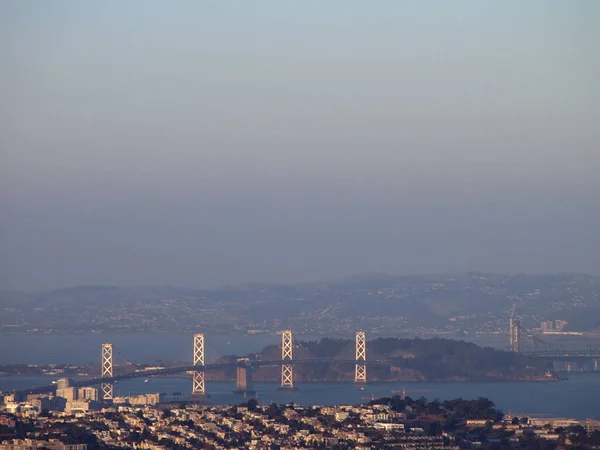 夕暮れ時に建設中のサンフランシスコ ベイブリッジ 宝島と新しい橋の空中ビュー — ストック写真