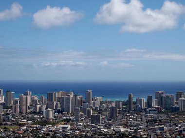 Oahu, Hawaii 'de bulutlu bir gökyüzünün altında yoğun bir Honolulu şehrini gösteriyor..