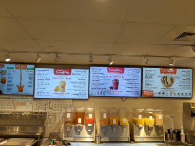 Honolulu - November 28, 2017: A Honolulu Jamba Juice interior, showing a menu with different smoothie options, as well as dispensers with multiple flavors. clipart