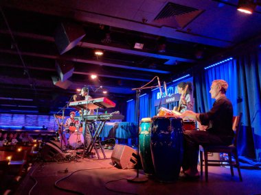 Waikiki - November 29, 2017: Ron Artis II performs live on stage at Blue Note Hawaii in Waikiki. The musician plays the keyboard while another musician plays the drums in the background. clipart