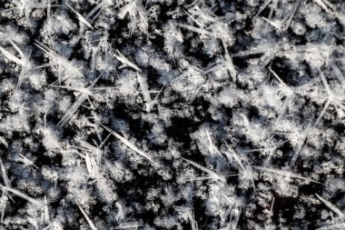 Hoarfrost and frost on the ice surface. On the icy surface of the river, large crystals of hoarfrost and frost formed.