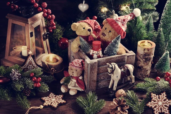 圣诞节还在继续 老泰迪熊戴着圣诞帽 头戴木箱 桌上摆放着乡村风格的玩具 — 图库照片