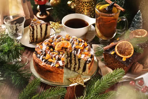 Homemade round zebra poppy seed cake, gingerbread cake with chocolate glaze and top decor and dried fruit compote for Christmas party