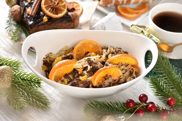 Top view of a bowl of noodles with poppy seeds and dried fruits as a traditional Polish dessert for Christmas Eve's supper