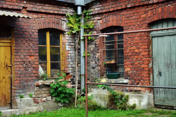 stock image Old brick building of lumber rooms or sheds in the yard of workers' housing estate