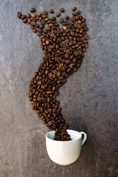 Spilled Cup Coffee Roasted Beans Forming Smoke Shape Vertical — Stock Photo, Image