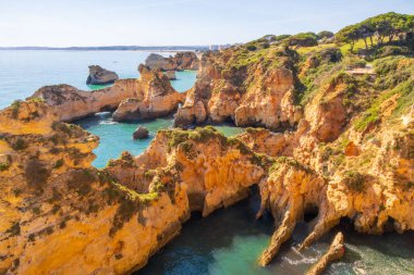 View over the jagged cliffs of Praia do Ferta beach near Alvor, Portugal clipart