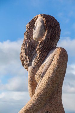 Carnoet, Bretagne, France - March 22th 2017 : Granite statue of Riwanon in the Valley of the Saints clipart