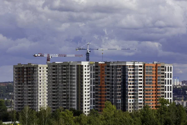 New cheap high-rise apartment building block under construction in Russia. Distant telephoto shot.