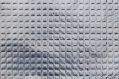 Full-frame texture of aluminum coated butil rubber sheet with square pattern. This material is used for sound dampening in car interiors and vibration resonance reducing and acoustic improving. clipart