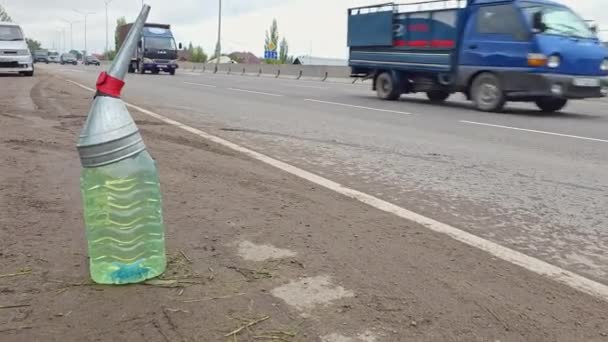 Cars Passing Plastic Bottles Gasoline Side Road Filler Funnel Concept — стокове відео