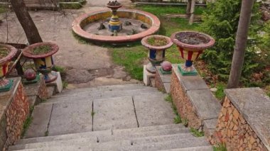 Kırgızistan 'da yaz günü eski Sovyet halkı Issyk-Ata bahçe merdivenlerinde süslü vazolar ve işlevsiz fıskiyeler..
