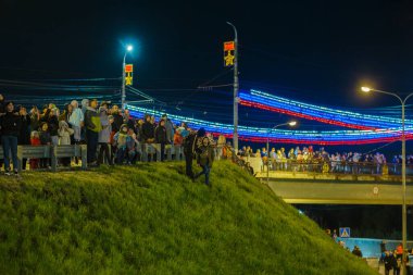Tepedeki ve köprüdeki Rus kalabalığı, 9 Mayıs 2021 'de Tula, Rusya' da gece gökyüzünde havai fişek gösterisi izliyorlar.