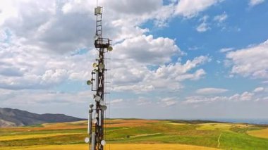 Kırgızistan 'da tarımsal alan ve dağ sırasının önündeki telekomünikasyon kulesi