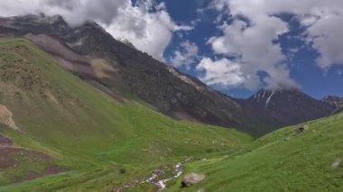Kırgızistan 'da güneşli yaz gününde yeşil yamaçlı muhteşem dağ geçidi. Tian-Shan dağlarının tepesindeki mavi gökyüzü, insansız hava aracı bakış açısı.