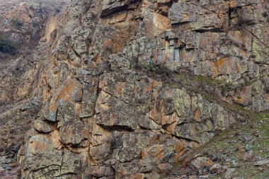 Rugged sedimentary cliff at spring day, full-frame background