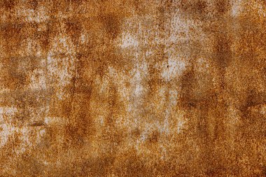 Weathered metal surface showcases deep rust and grunge texture in industrial outdoor setting. Daytime light enhances the rugged details, creating a raw, authentic atmosphere.