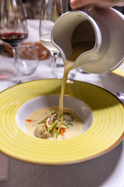 Creative gourmet soup with original serving in restaurant