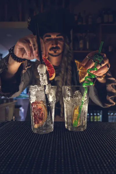Bartender of Halloween night making a party drink.  Halloween party concept.