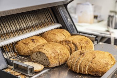 Bread slicer machine in bakery production line clipart