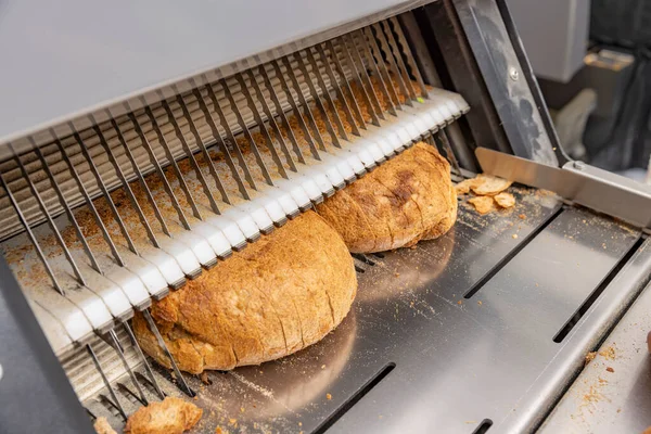 Bread slicing machine. Sliced bread on the production line of food and bakery products.