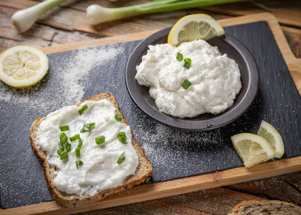 Lezzetli ev yapımı balık yumurtası yeşil soğan ve limonla birlikte ekmeğe yayılıyor.