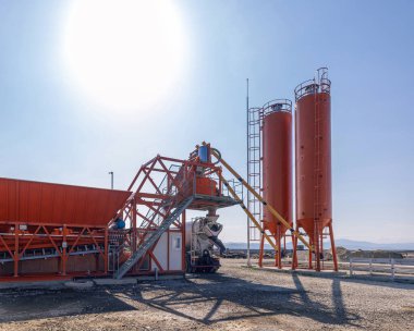 Concrete batching plant preparing concrete for a construction project clipart