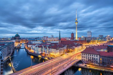 The center of Berlin with the famous TV Tower and a clouded sky at dusk