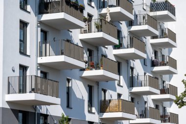 The facade of a modern white apartment building seen in Berlin, Germany