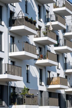 The facade of a modern white apartment building seen in Berlin, Germany