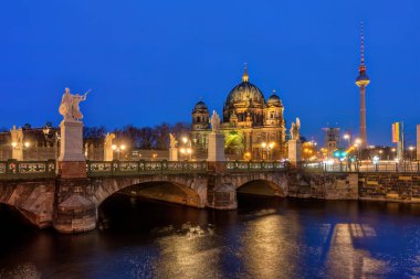 The Berlin Cathedral with the famous TV Tower at night clipart