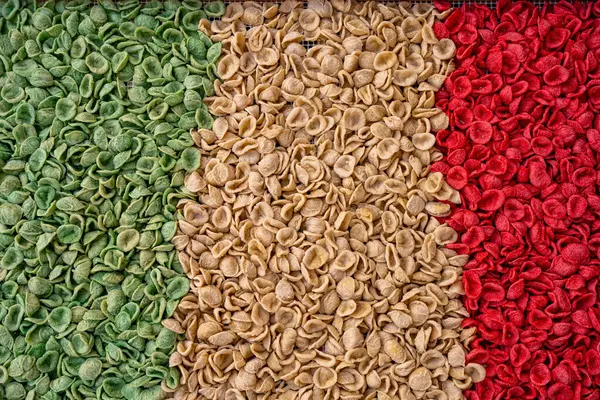 stock image Traditional apulian orecchiette in the colors of the Italian flag seen in the streets of Bari