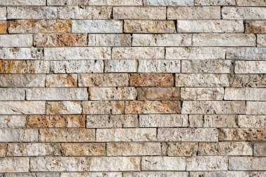 Background from a wall of beige and brown clinker bricks clipart