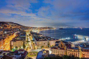 Naples with the Gulf and the famous Mount Vesuvius in clouds at dusk clipart