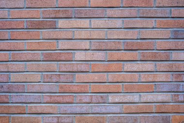 Kırmızımsı tuğlalardan yapılmış bir duvarın arka planı