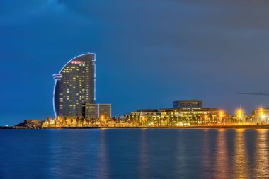 Barcelona, İspanya 'da Barceloneta plajı, mavi saatte.
