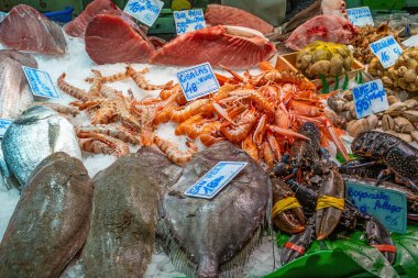 Fish monger with fresh fish and seafood seen in Barcelona, Spain