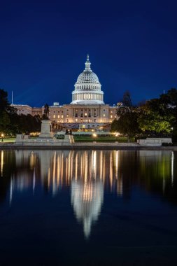 Washington DC 'de gece vakti ünlü yansıma havuzuyla aydınlatılan Birleşik Devletler Kongre Binası.