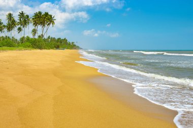 Sea waves and beautiful sky with white clouds.