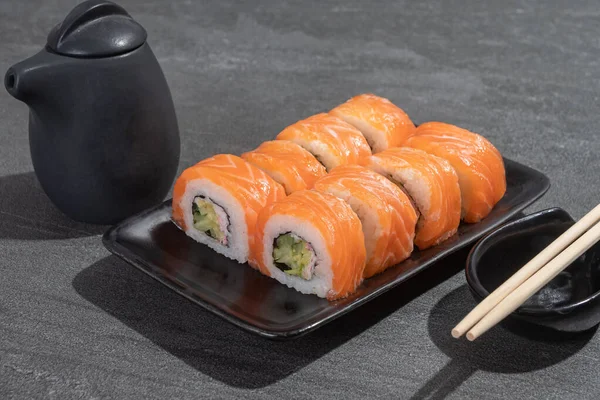 Sushi Rolls Salmon Avocado Cucumber Black Rectangular Plate Black Stone — Stock Photo, Image