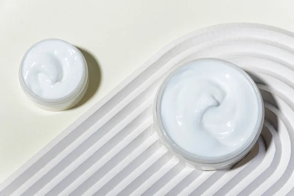 Moisturizing facial cream with peptides and microelements against skin aging. Minimalism style
