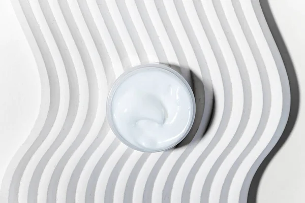 Moisturizing facial cream with peptides and microelements against skin aging. Minimalism style