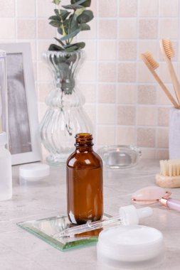 Home skin care, SPA. Hyaluronic moisturizing serum on the bathroom shelf. Simple steps for healthy skin