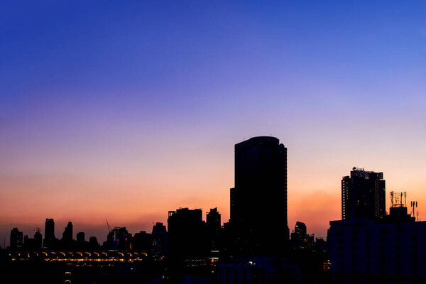 Silhouette cityscape in twilight time with colorful sky