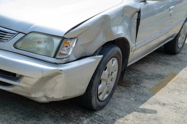 a scared marks on a front-left car body from accidentally hit by fast drive motorcycle, show broken mirror of flashlight cover 