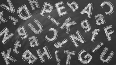 Büyük ve küçük harfli Latince harfler bir okul tahtasına tebeşirle yazılır..