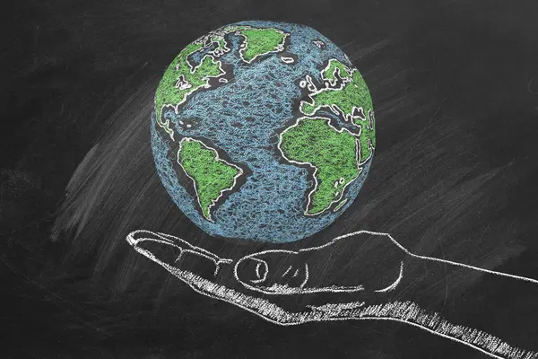 The Globe in a man\'s hand. Chalk drawn illustration. Save the World. Peace or global business concept. Earth day concept. Travel concept. Trip around the world.